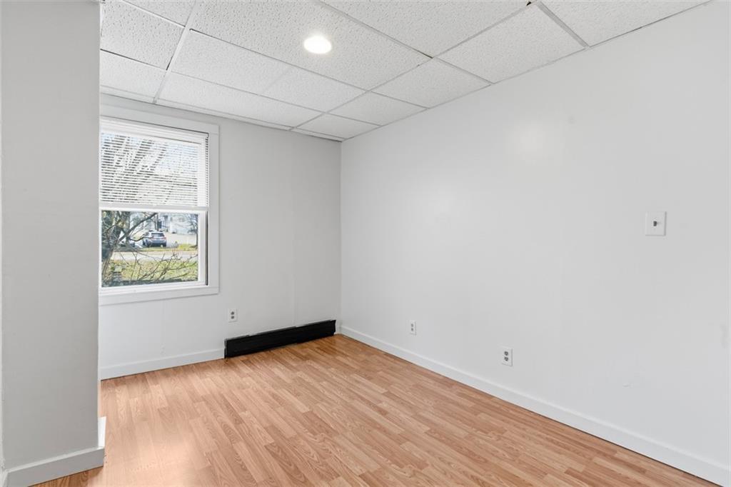 1057 Keene Street Springdale, PA 15144 - Photo 43 of 50 an empty room with wooden floor and windows