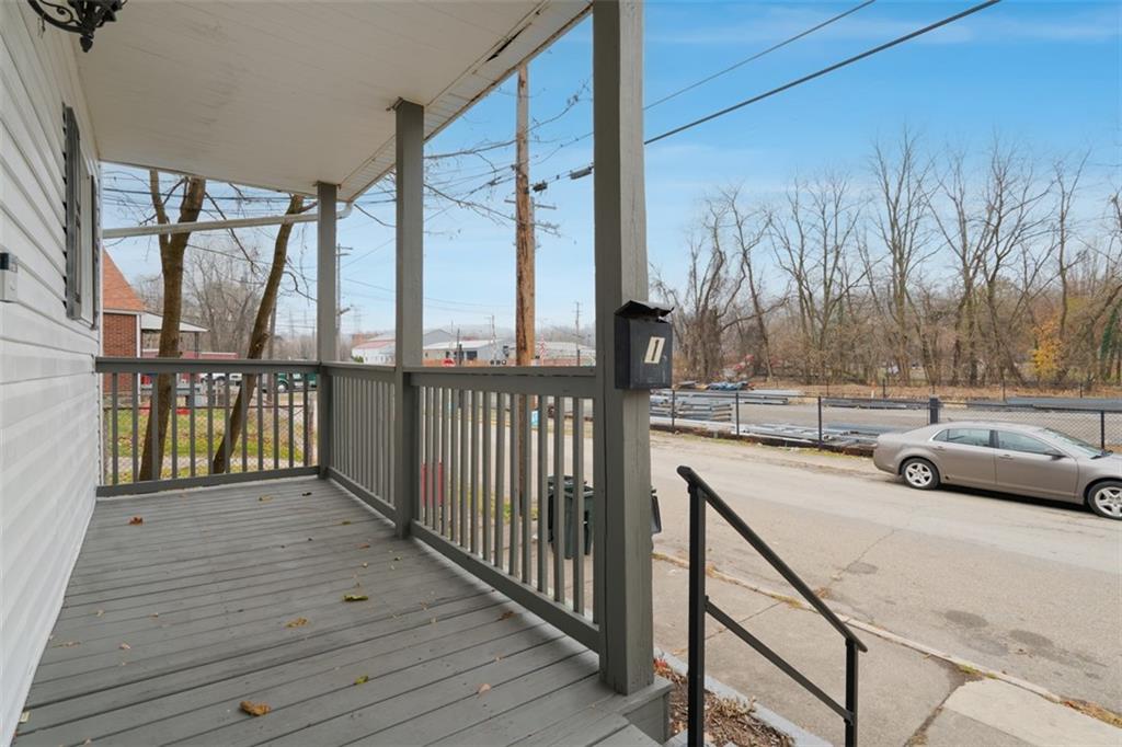 1057 Keene Street Springdale, PA 15144 - Photo 5 of 50 a view of a balcony with furniture and wooden floor
