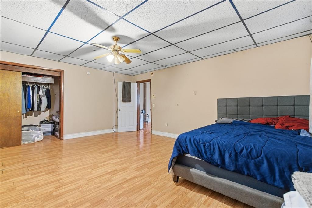 1057 Keene Street Springdale, PA 15144 - Photo 9 of 50 a bedroom with a bed and a chandelier