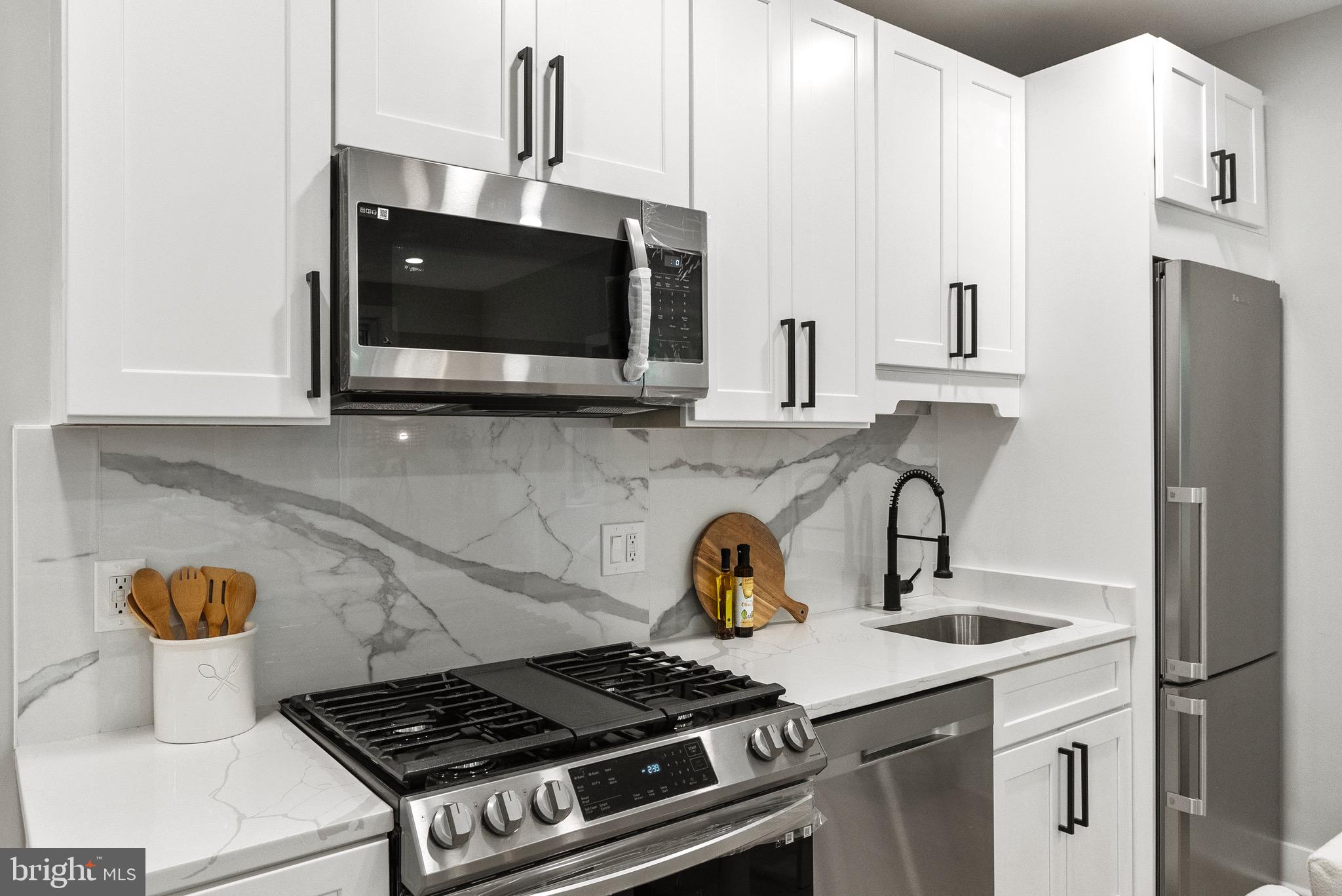 2019 M Street Northeast, Unit 1 Washington, DC 20002 - Photo 4 of 31 a kitchen with a stove and a microwave