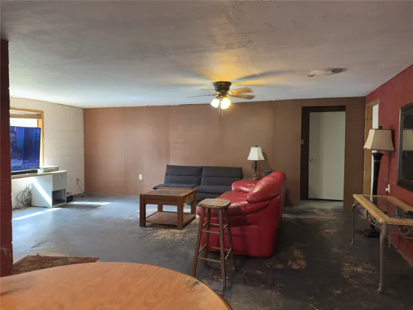 a living room with furniture a lamp and a fireplace