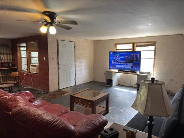 a living room with furniture and a chandelier