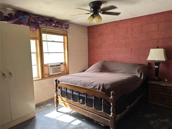 a bed sitting in a bedroom next to a window