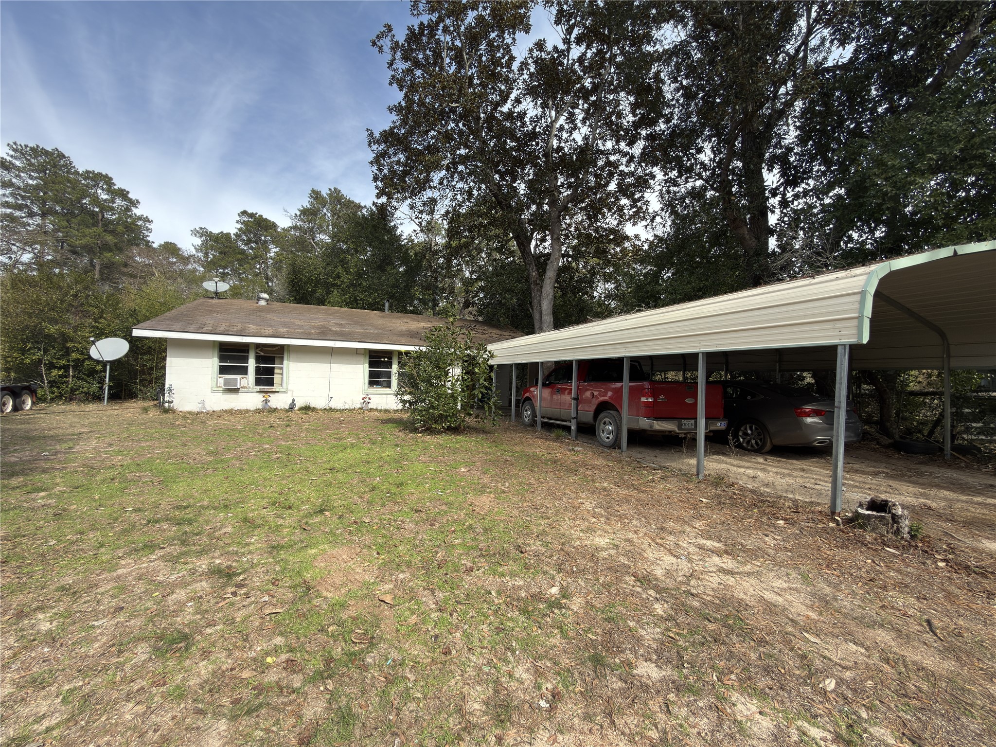 257 County Road 2142 Cleveland, TX 77327 - Photo 2 of 18 a backyard of a house with barbeque oven table and chairs