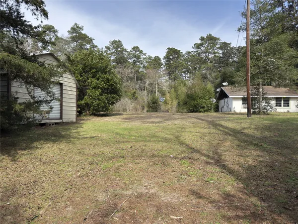 a view of a field with trees in the background