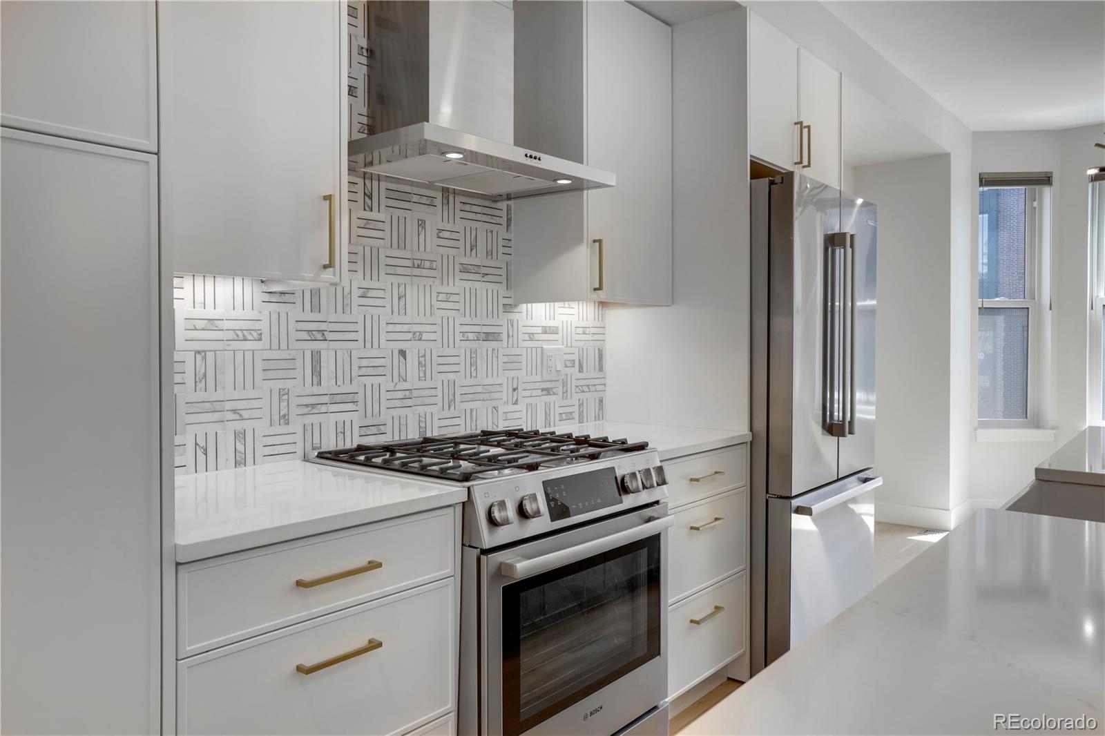 1065-25 25th Street, Unit A Denver, CO 80205 - Photo 12 of 45 a stove top oven sitting inside of a kitchen