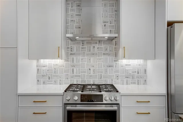 a stove top oven sitting inside of a kitchen