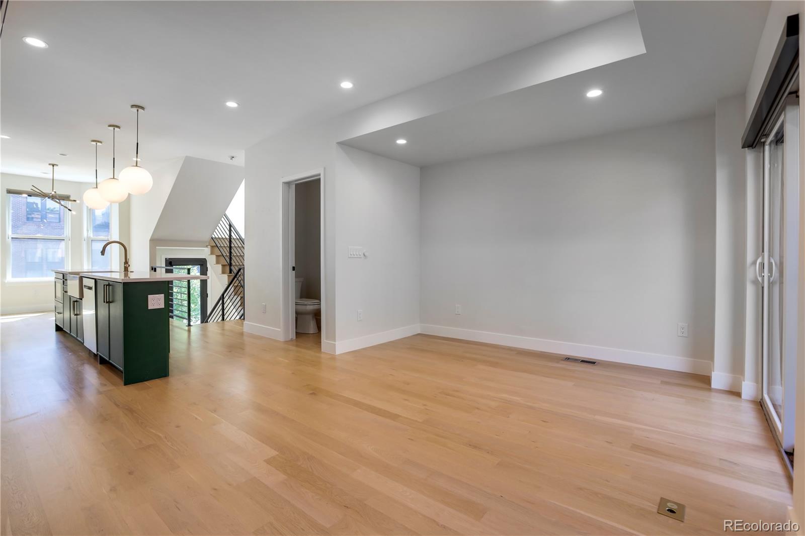 1065-25 25th Street, Unit A Denver, CO 80205 - Photo 26 of 45 a view of a big room with wooden floor and windows