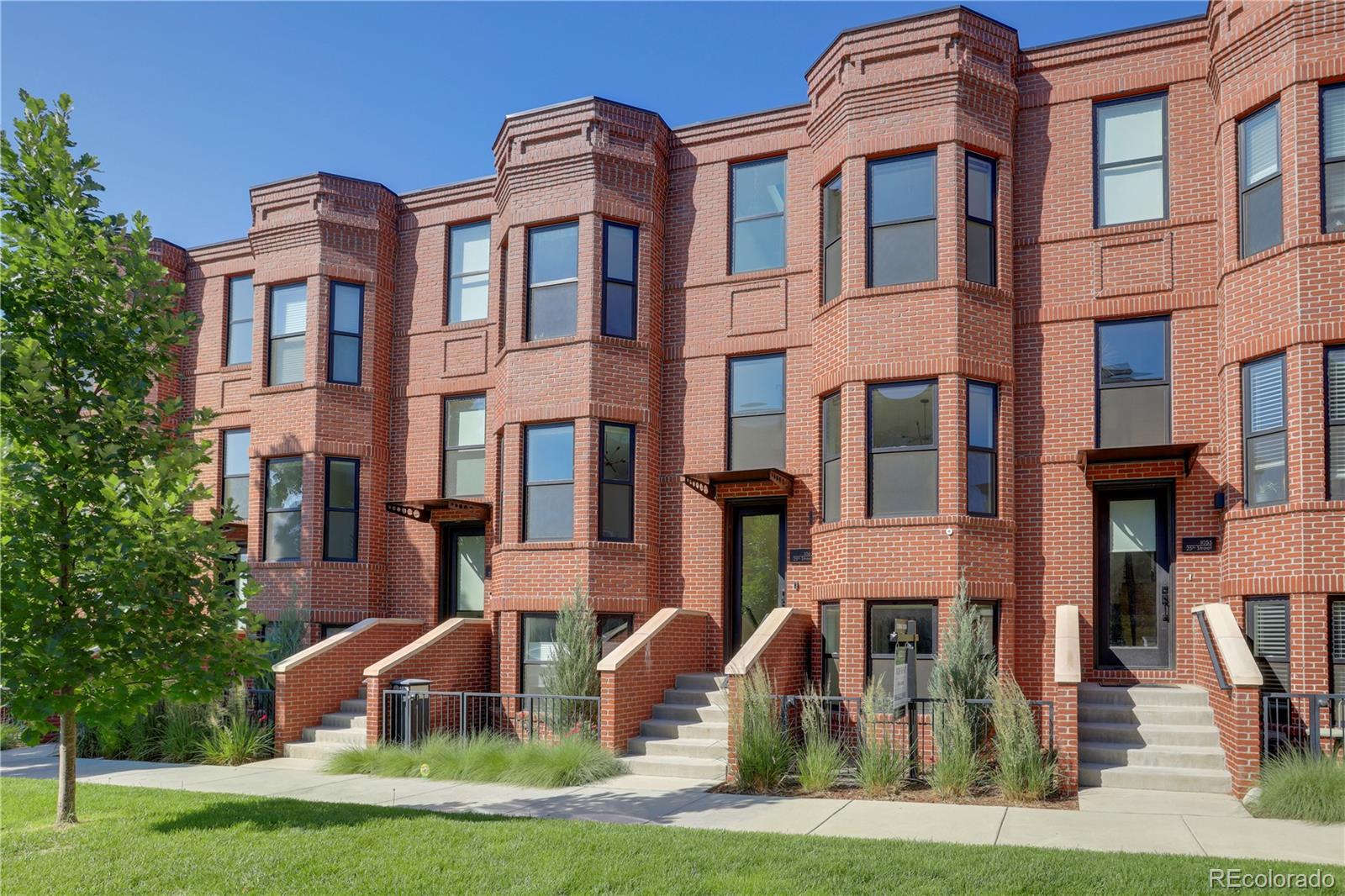 1065-25 25th Street, Unit A Denver, CO 80205 - Photo 43 of 45 a front view of a residential apartment building with a yard