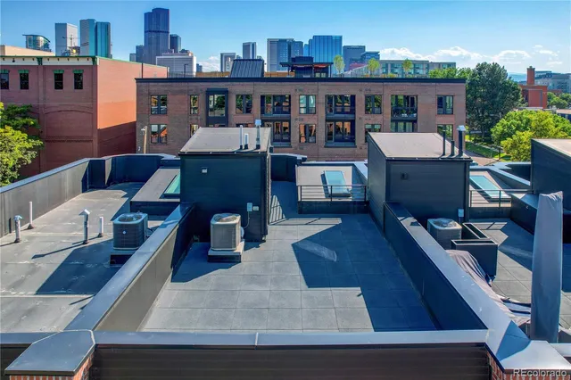 a view of a patio with couches table and chairs with potted plants