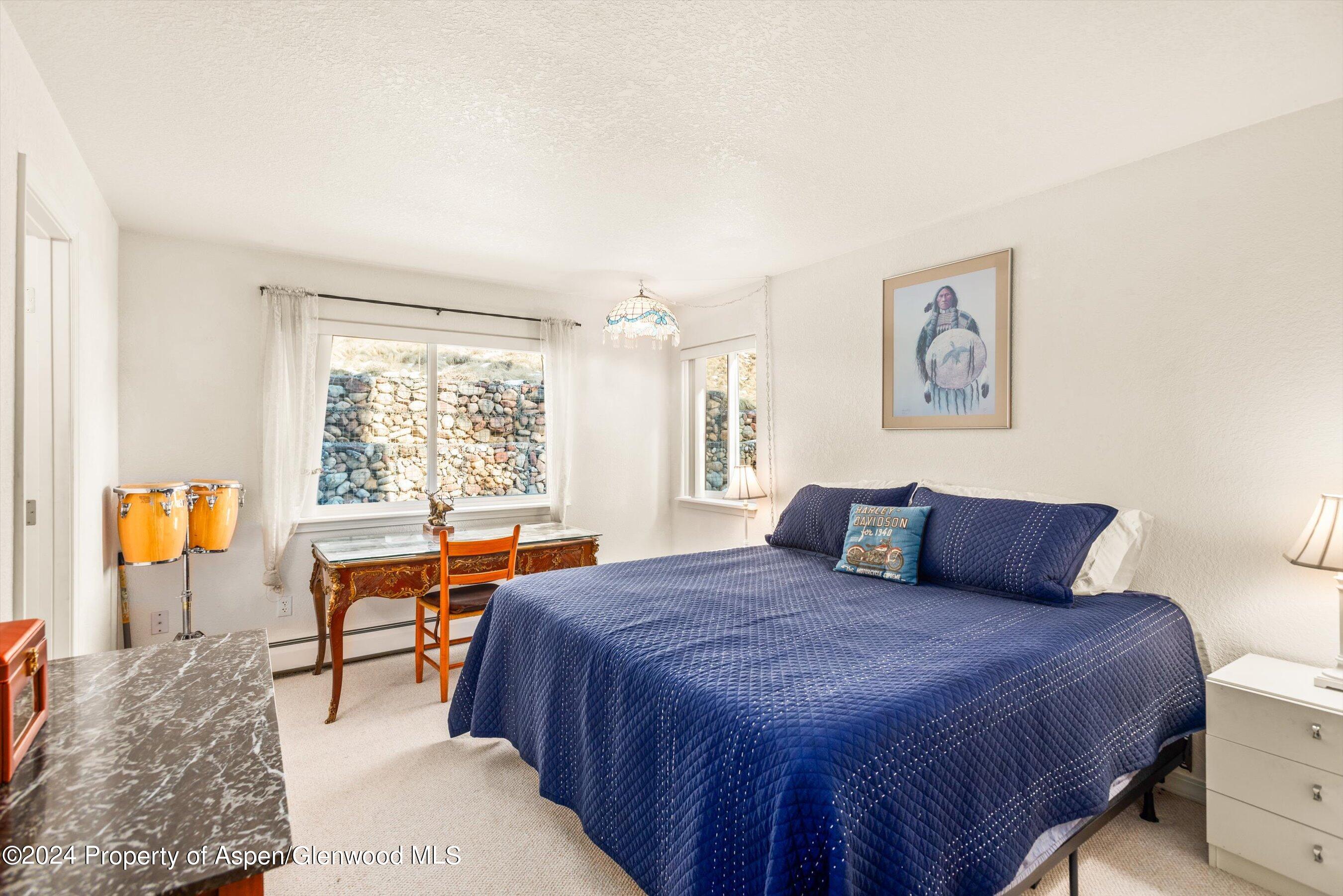 16 Pine Ridge Road Basalt, CO 81621 - Photo 58 of 63 a bedroom with a large bed and a window