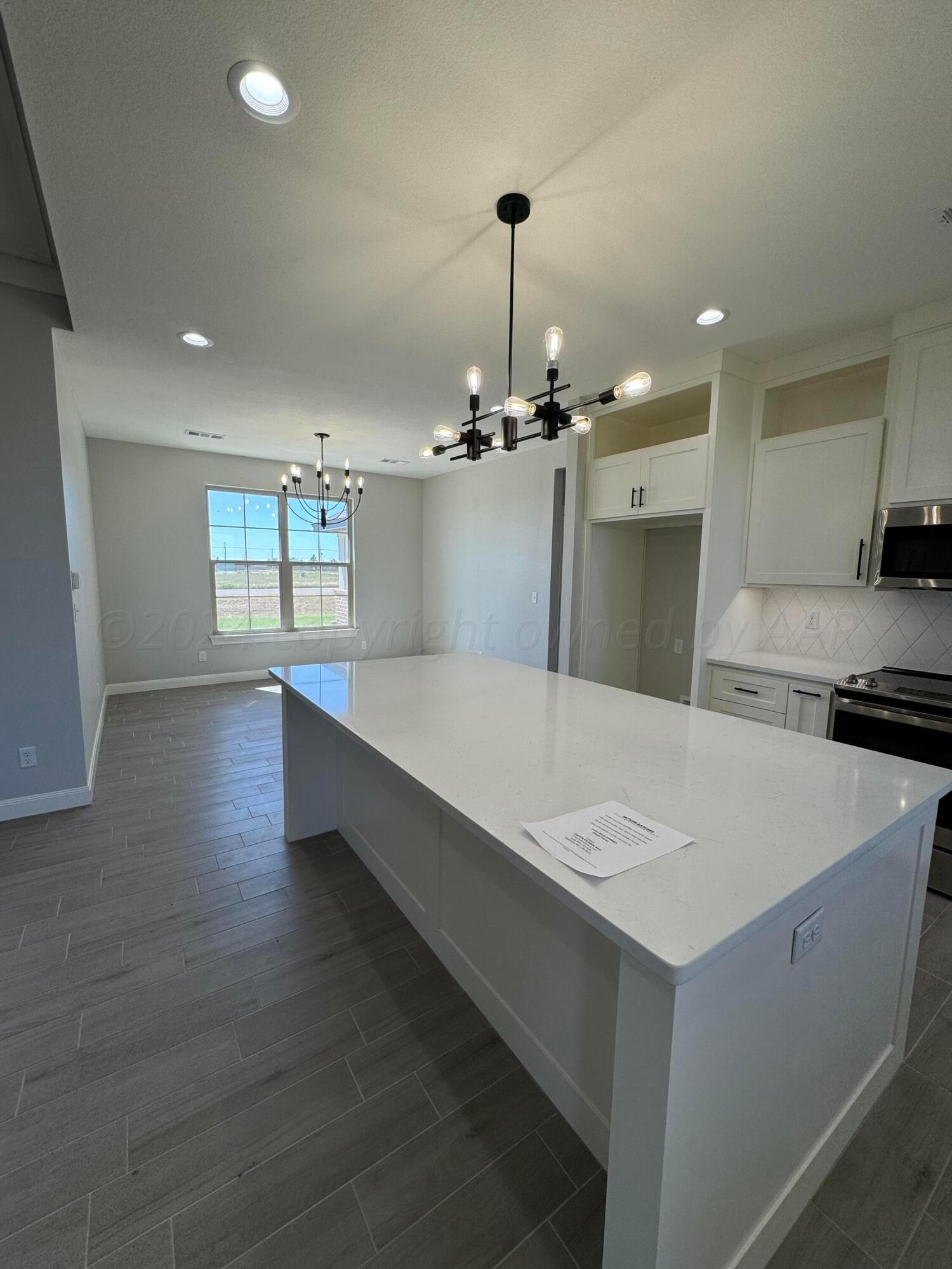 3801 Whitetail Springs Road Amarillo, TX 79119 - Photo 2 of 13 a large kitchen with kitchen island a sink stainless steel appliances and cabinets