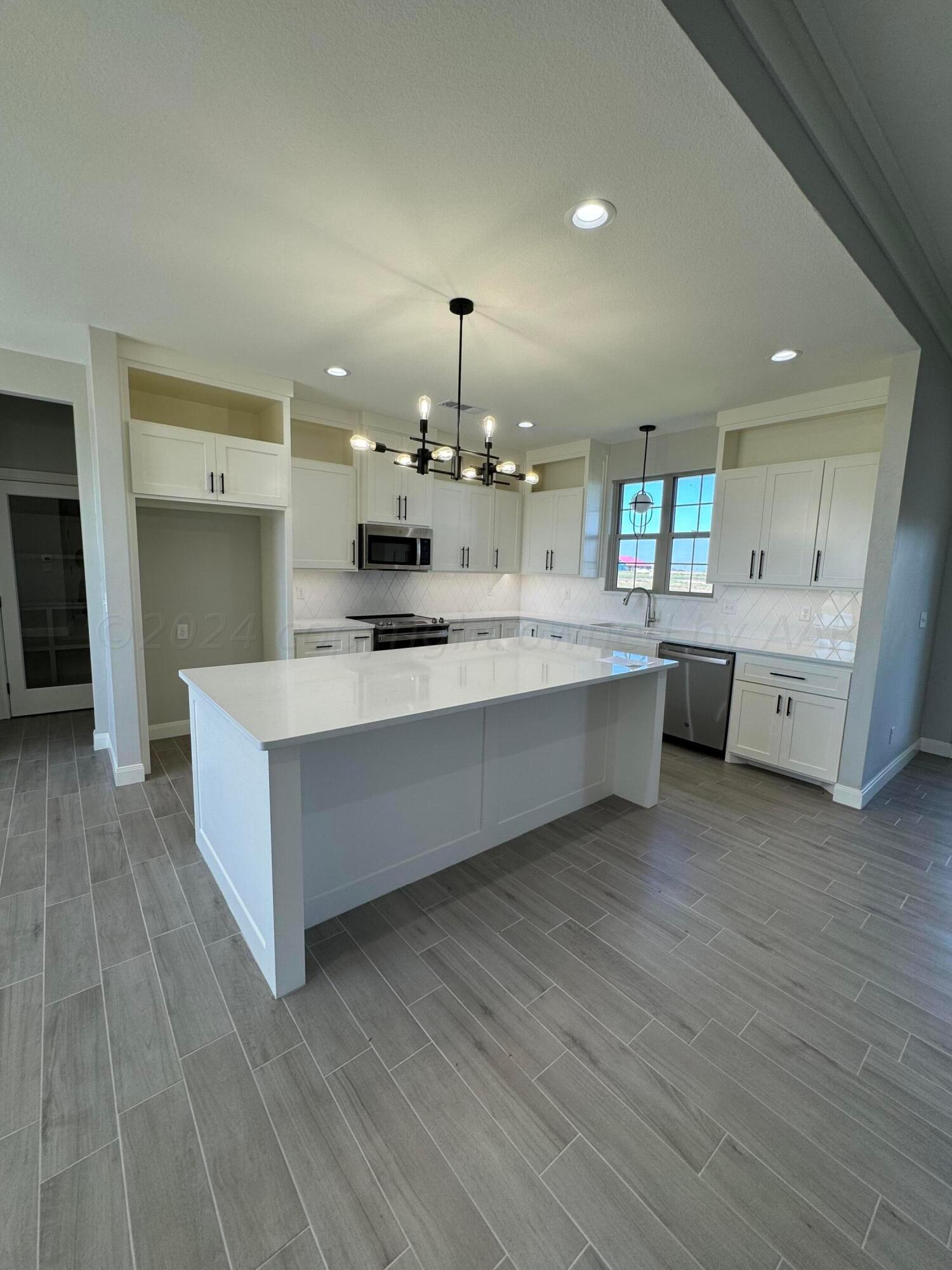 3801 Whitetail Springs Road Amarillo, TX 79119 - Photo 3 of 13 a large white kitchen with a white countertops and cabinets