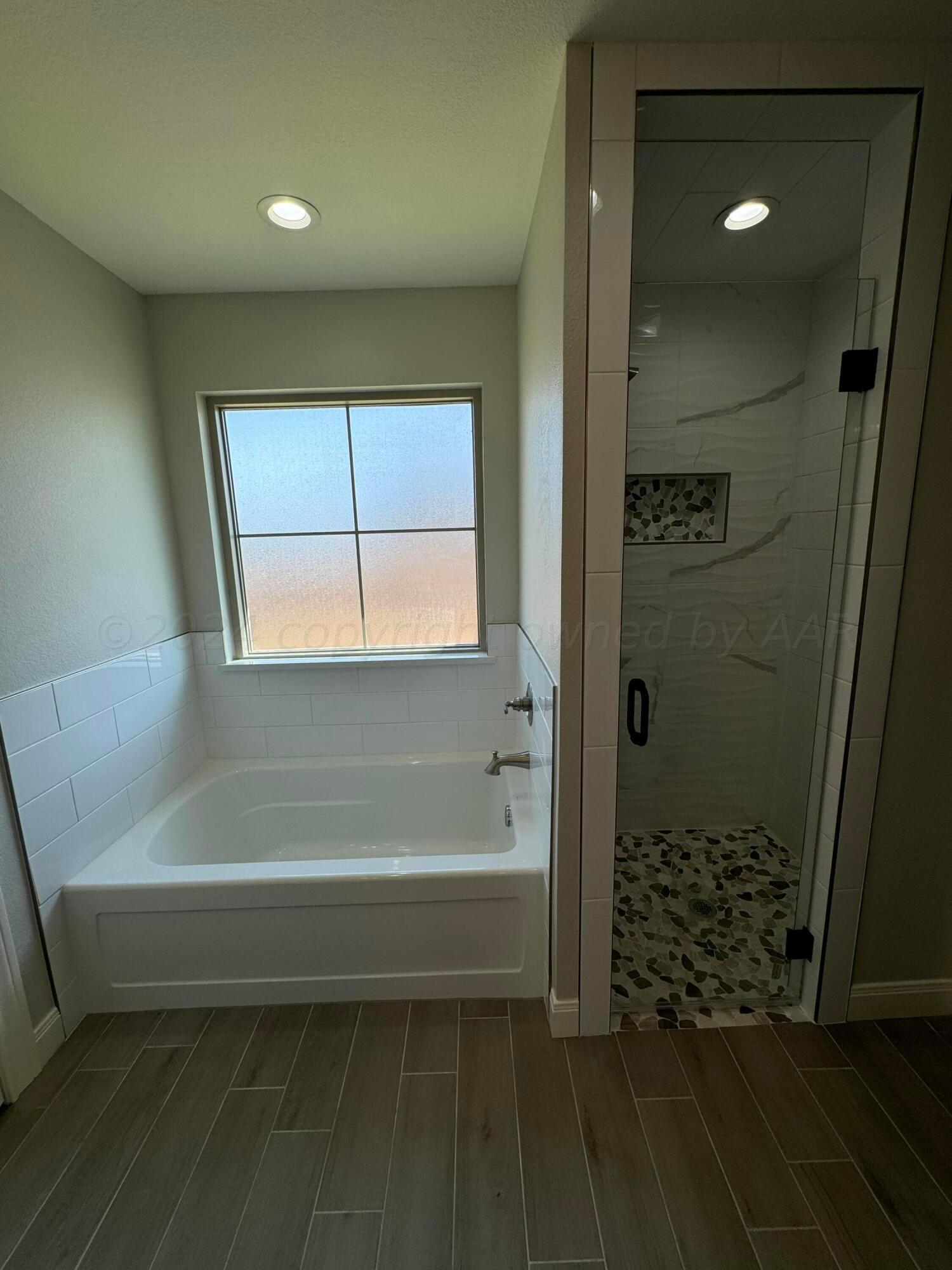 3801 Whitetail Springs Road Amarillo, TX 79119 - Photo 6 of 13 a bathroom with a bathtub and a shower