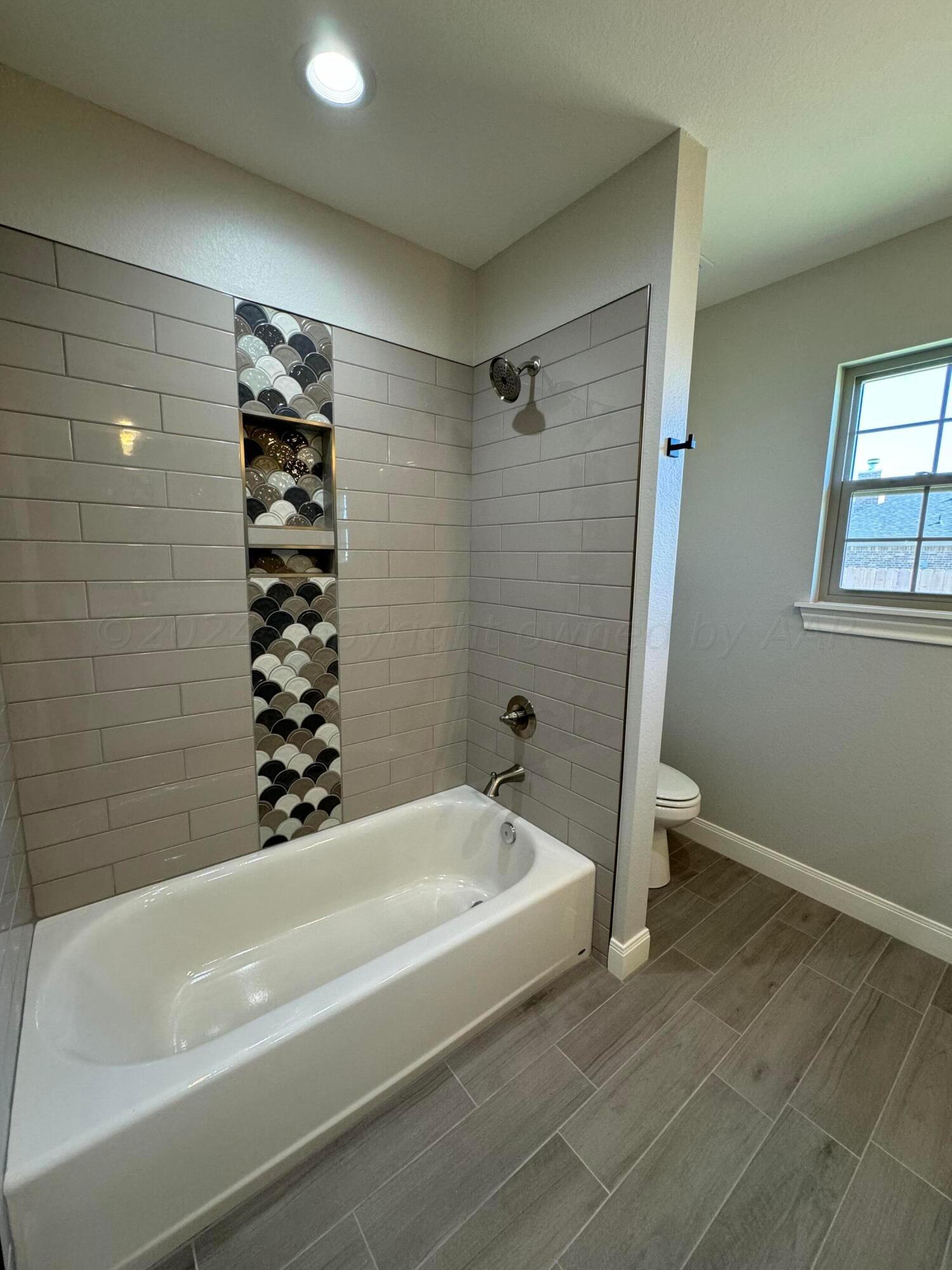 3801 Whitetail Springs Road Amarillo, TX 79119 - Photo 8 of 13 a bathroom with a bathtub and shower