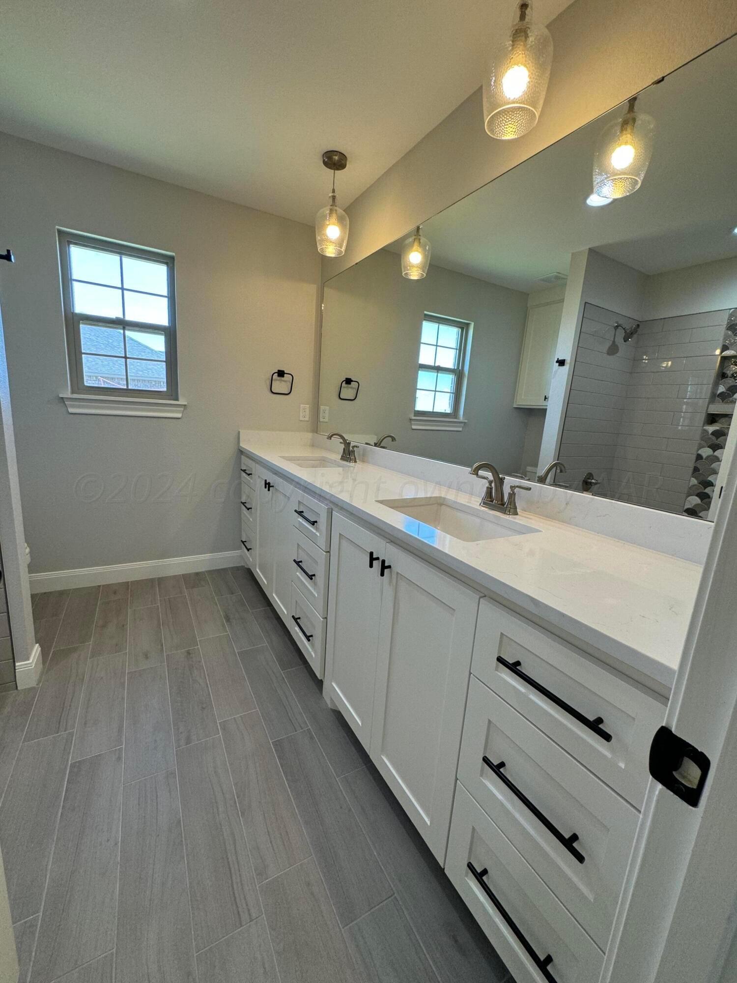 3801 Whitetail Springs Road Amarillo, TX 79119 - Photo 9 of 13 a bathroom with a double vanity sink and mirror