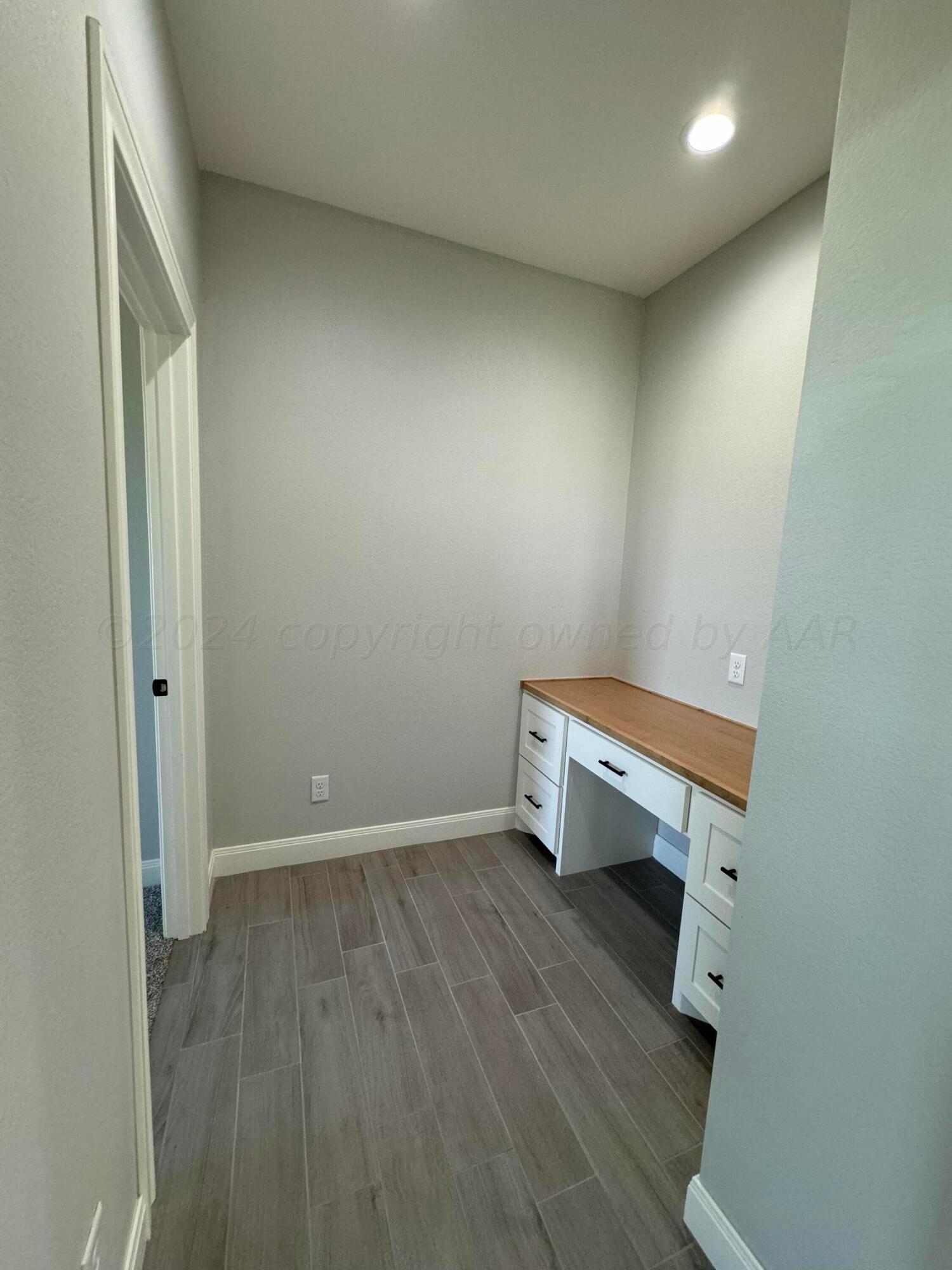 3801 Whitetail Springs Road Amarillo, TX 79119 - Photo 10 of 13 an empty room with wooden floor and white walls