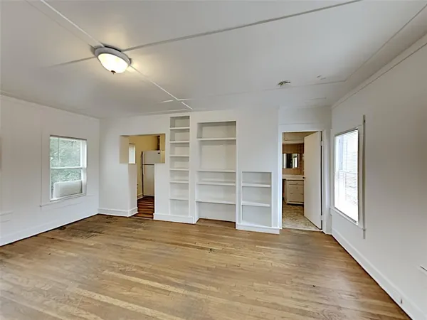 a view of wooden floor and windows in a room