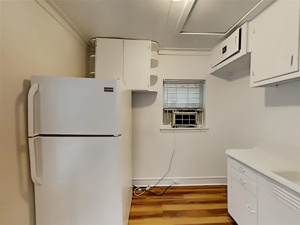 a white refrigerator freezer and a stove sitting inside of a kitchen