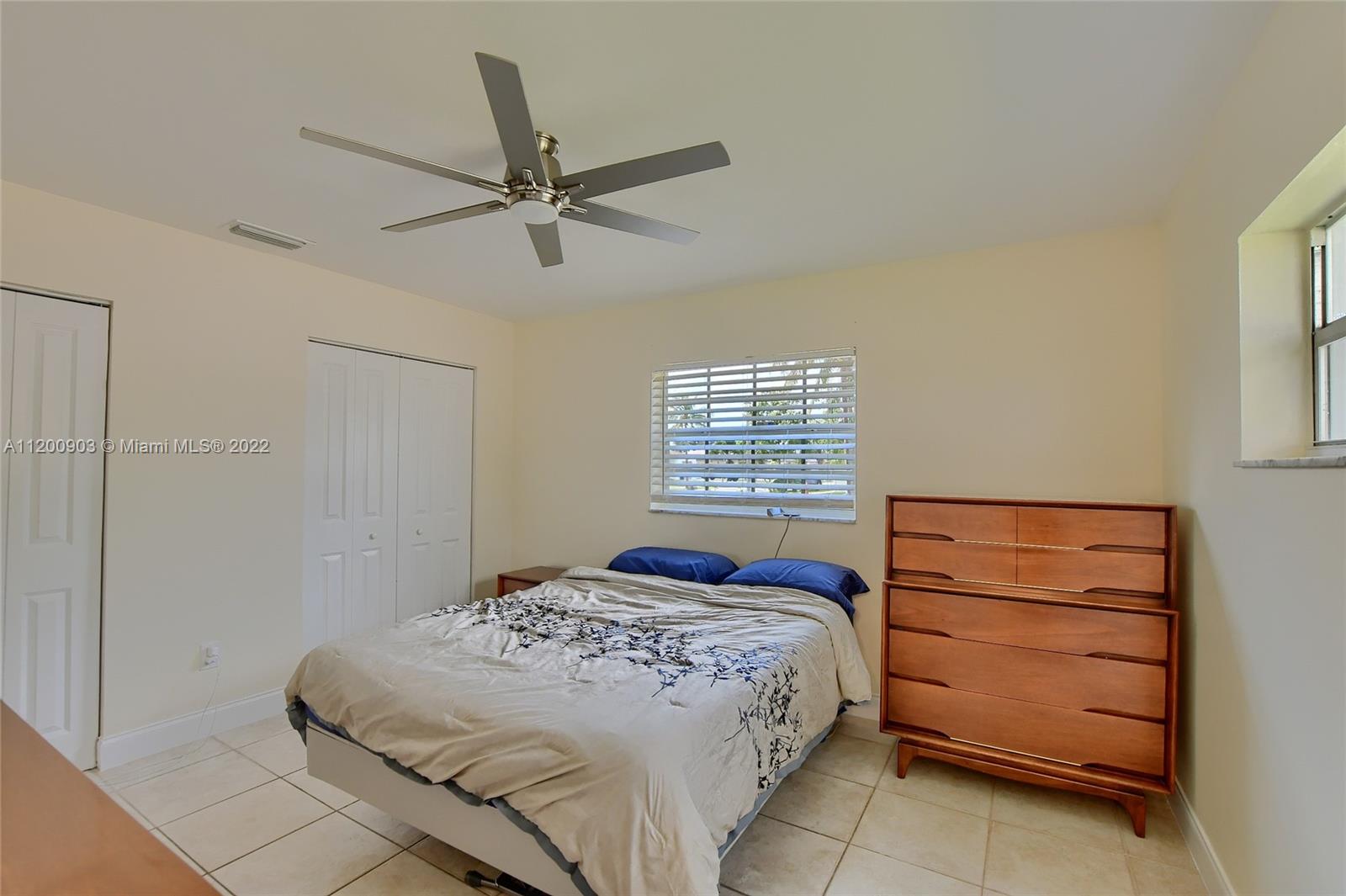 10950 Granite Street Boca Raton, FL 33428 - Photo 13 of 27 a bedroom with a bed and a window