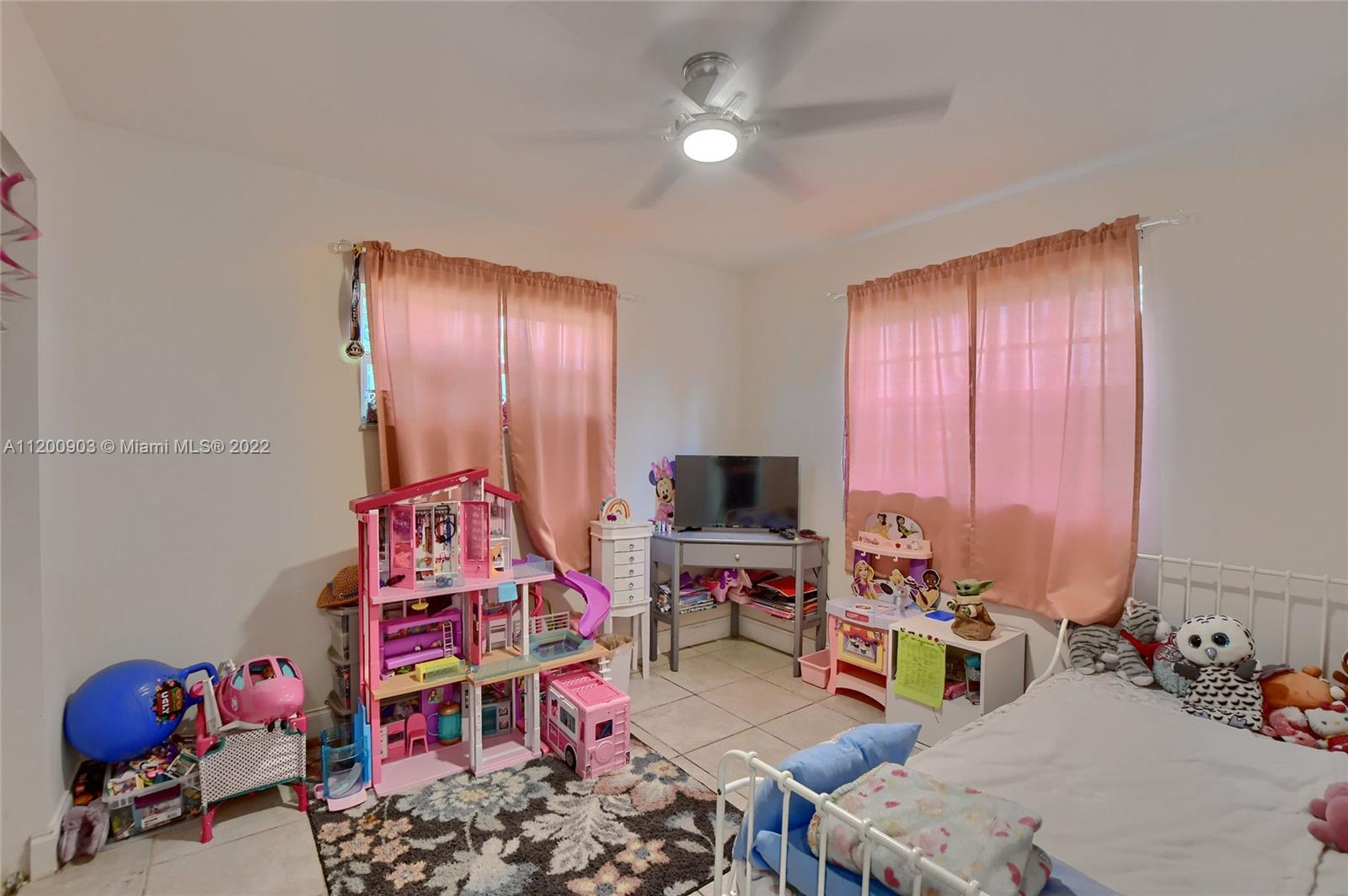 10950 Granite Street Boca Raton, FL 33428 - Photo 15 of 27 a living room with furniture a flat screen tv and a window