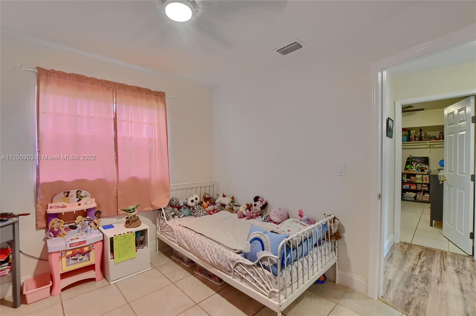 10950 Granite Street Boca Raton, FL 33428 - Photo 16 of 27 a bed room with a bed and a window
