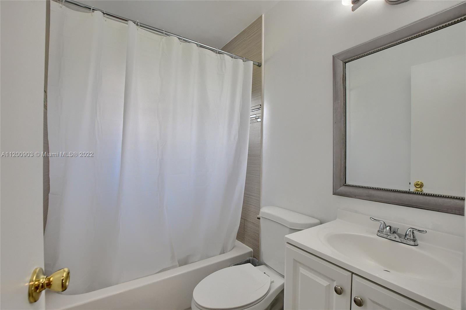 10950 Granite Street Boca Raton, FL 33428 - Photo 17 of 27 a bathroom with a sink toilet and a mirror