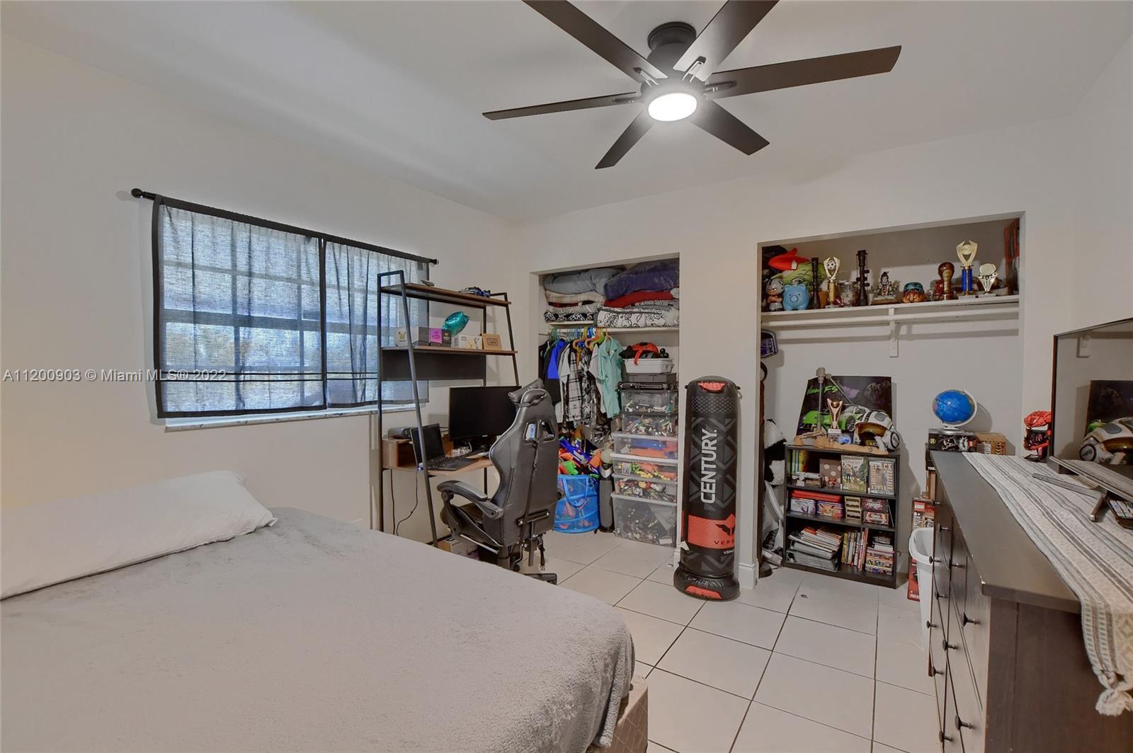 10950 Granite Street Boca Raton, FL 33428 - Photo 18 of 27 a bedroom with bed and a window