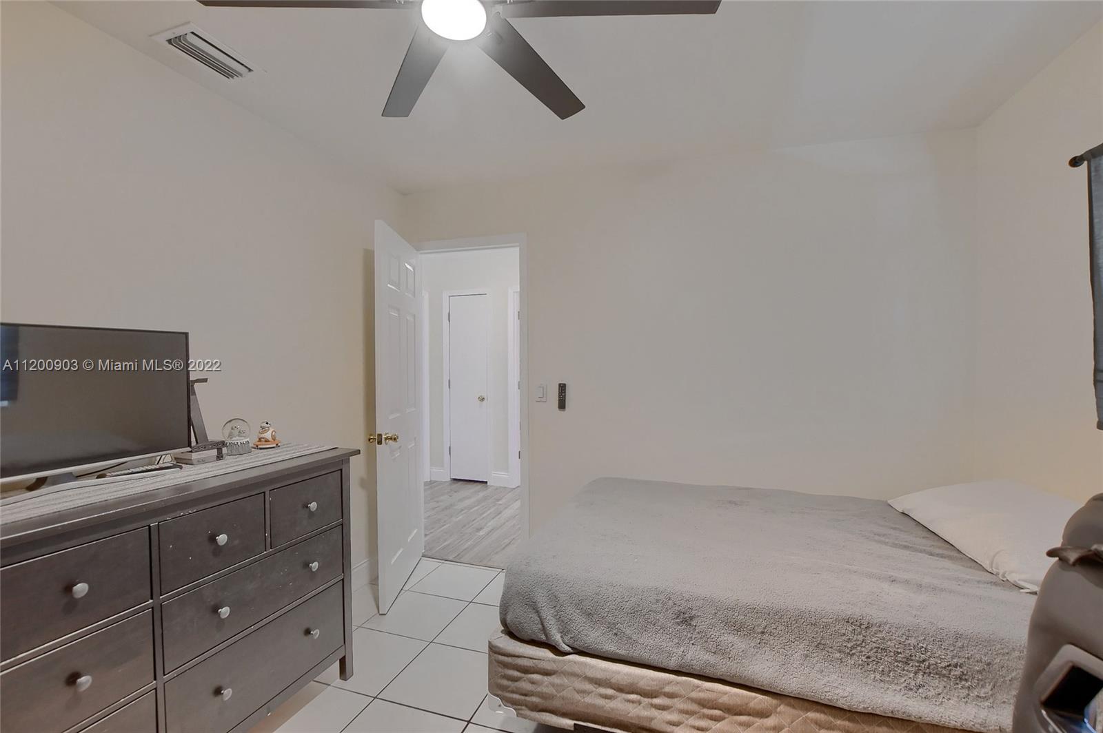 10950 Granite Street Boca Raton, FL 33428 - Photo 19 of 27 a bedroom with a bed and a ceiling fan