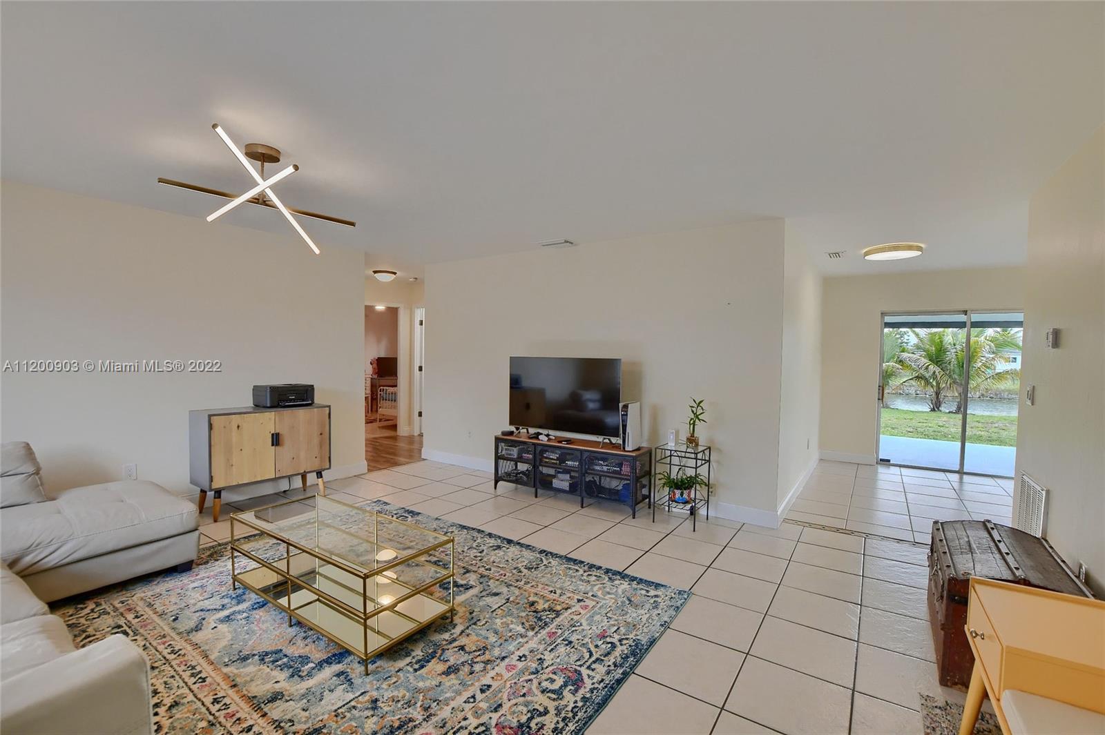10950 Granite Street Boca Raton, FL 33428 - Photo 2 of 27 a living room with furniture and a flat screen tv