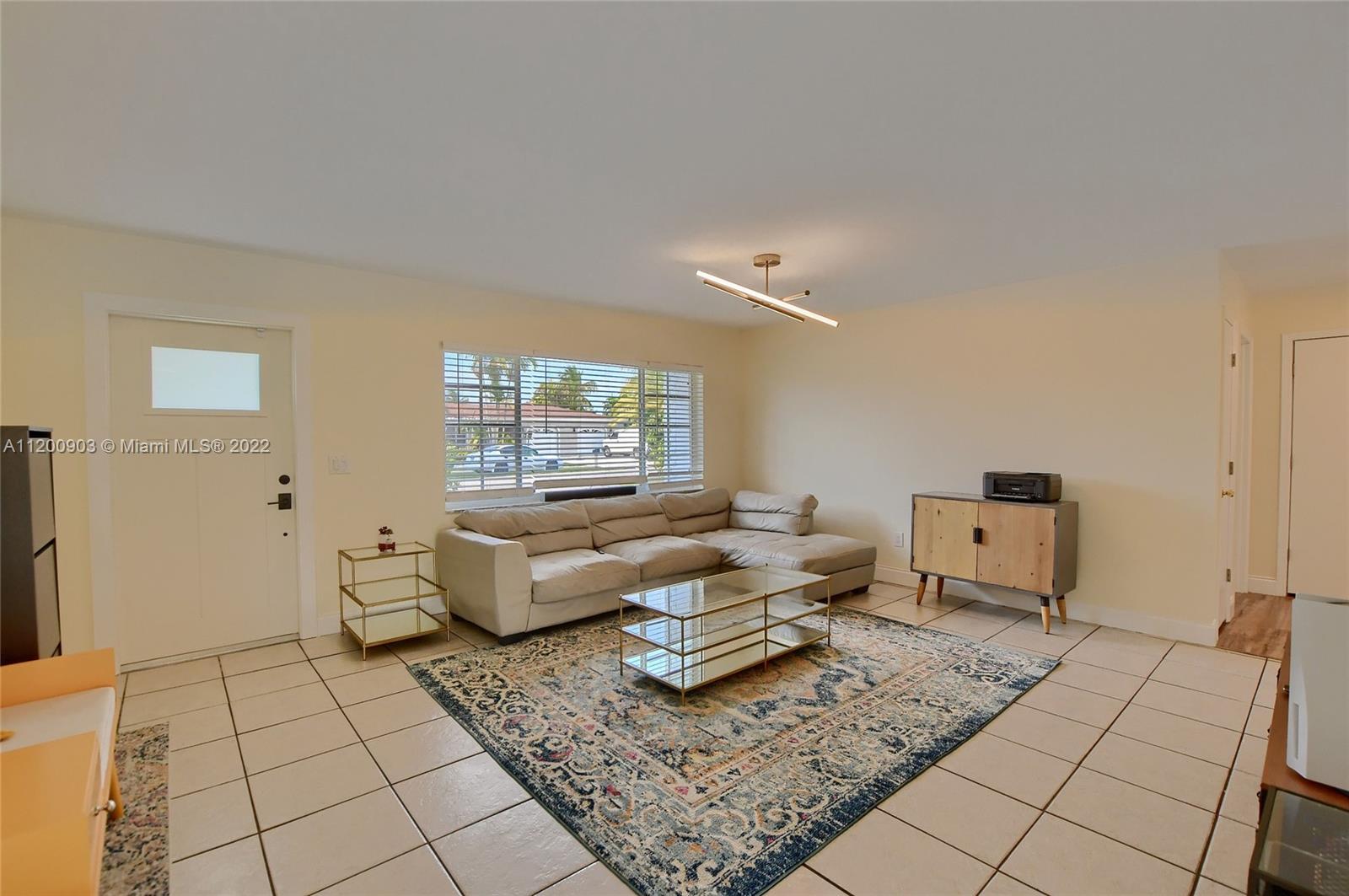 10950 Granite Street Boca Raton, FL 33428 - Photo 21 of 27 a living room with furniture and a rug
