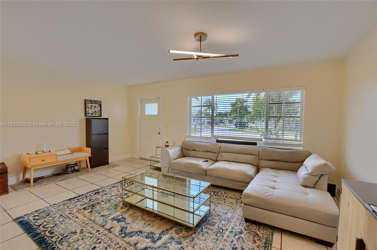 10950 Granite Street Boca Raton, FL 33428 - Photo 22 of 27 a living room with furniture and a window