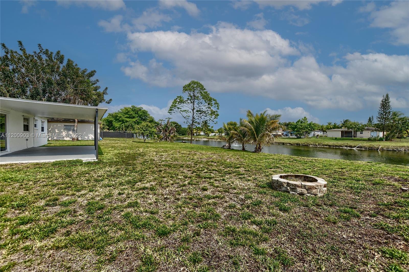 10950 Granite Street Boca Raton, FL 33428 - Photo 25 of 27 a view of a lake with a big yard and large trees