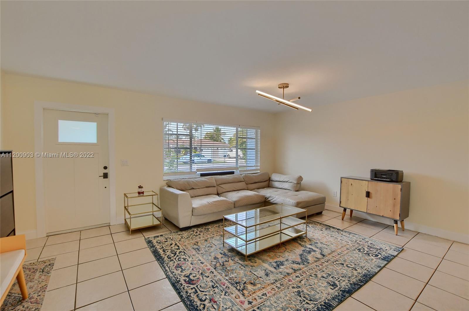 10950 Granite Street Boca Raton, FL 33428 - Photo 7 of 27 a living room with furniture and a rug