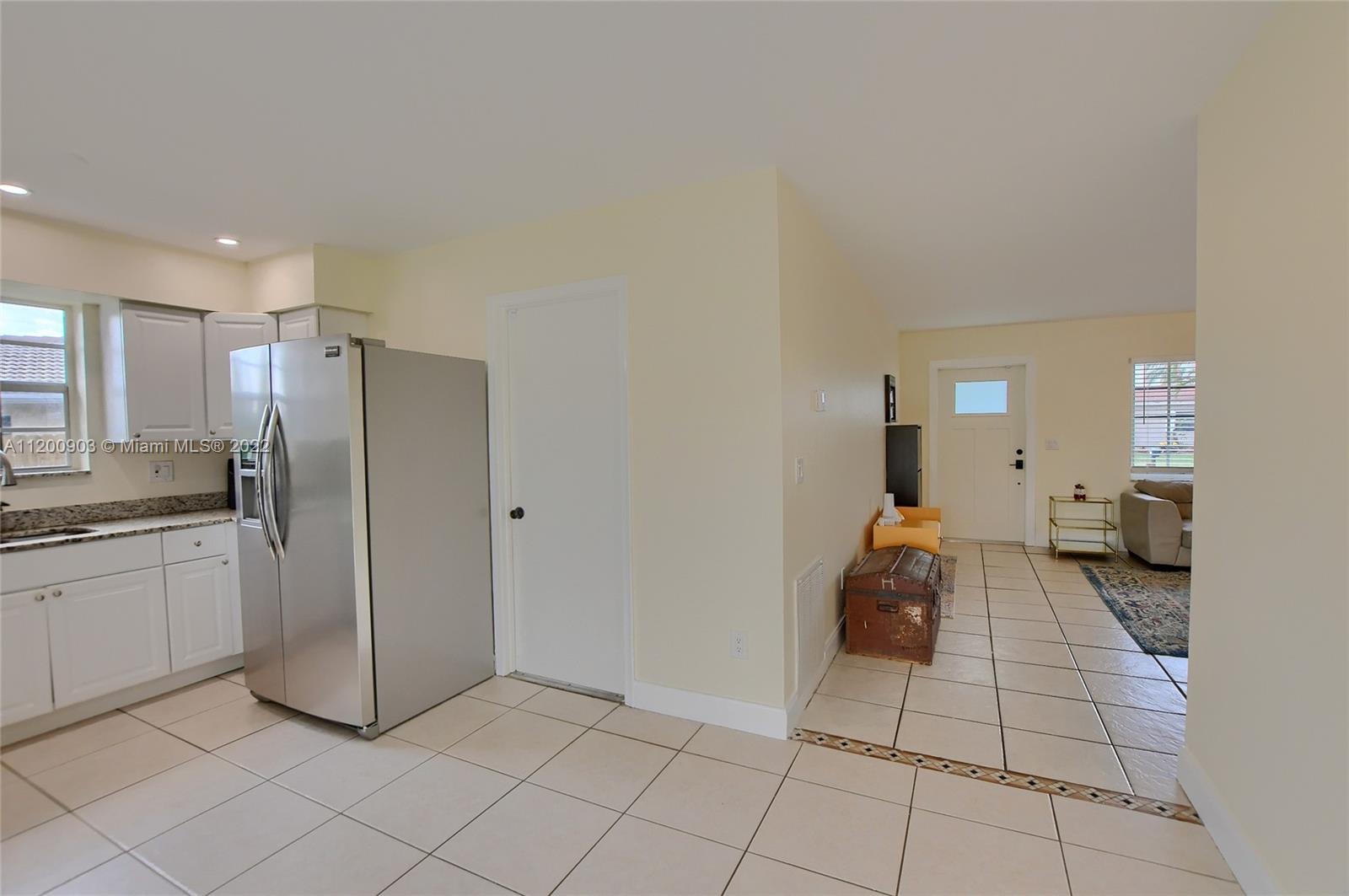 10950 Granite Street Boca Raton, FL 33428 - Photo 9 of 27 a kitchen with a refrigerator and a stove top oven