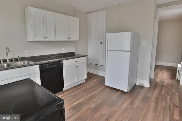 a kitchen with a cabinets and wooden floor
