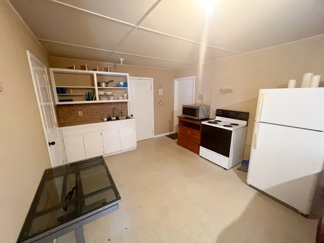 a kitchen with stainless steel appliances a stove a sink and a refrigerator