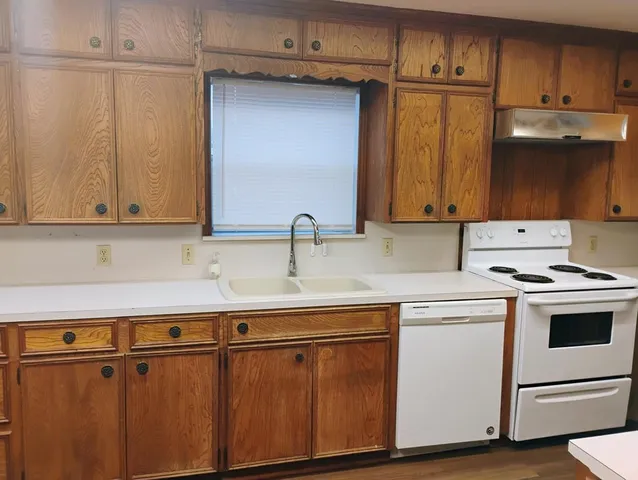 a kitchen with stainless steel appliances granite countertop a sink and a microwave
