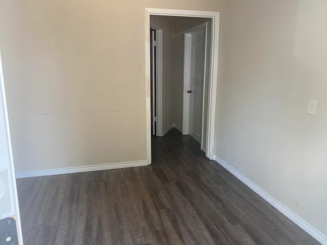 a view of a room with wooden floor