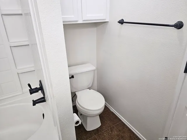 a white toilet sitting next to a sink