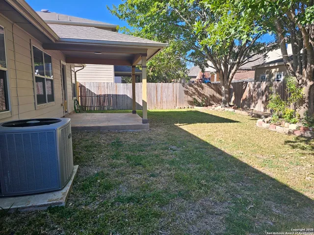 a view of backyard with a tub and trees