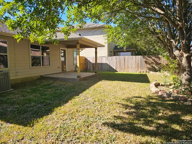 a backyard of a house with table and chairs