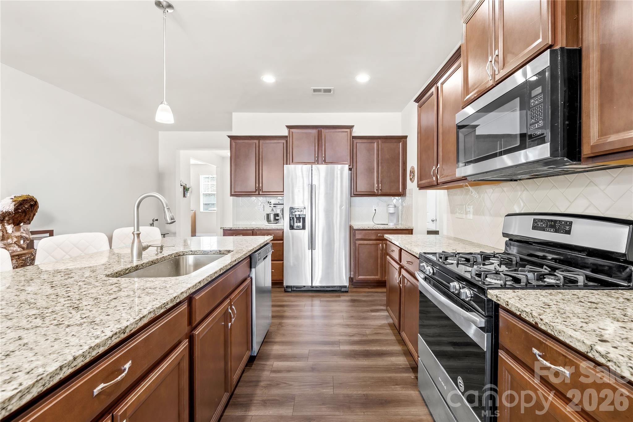 1721 Bailey Ridge Drive York, SC 29745 - Photo 8 of 32 a kitchen with stainless steel appliances granite countertop a sink stove and refrigerator