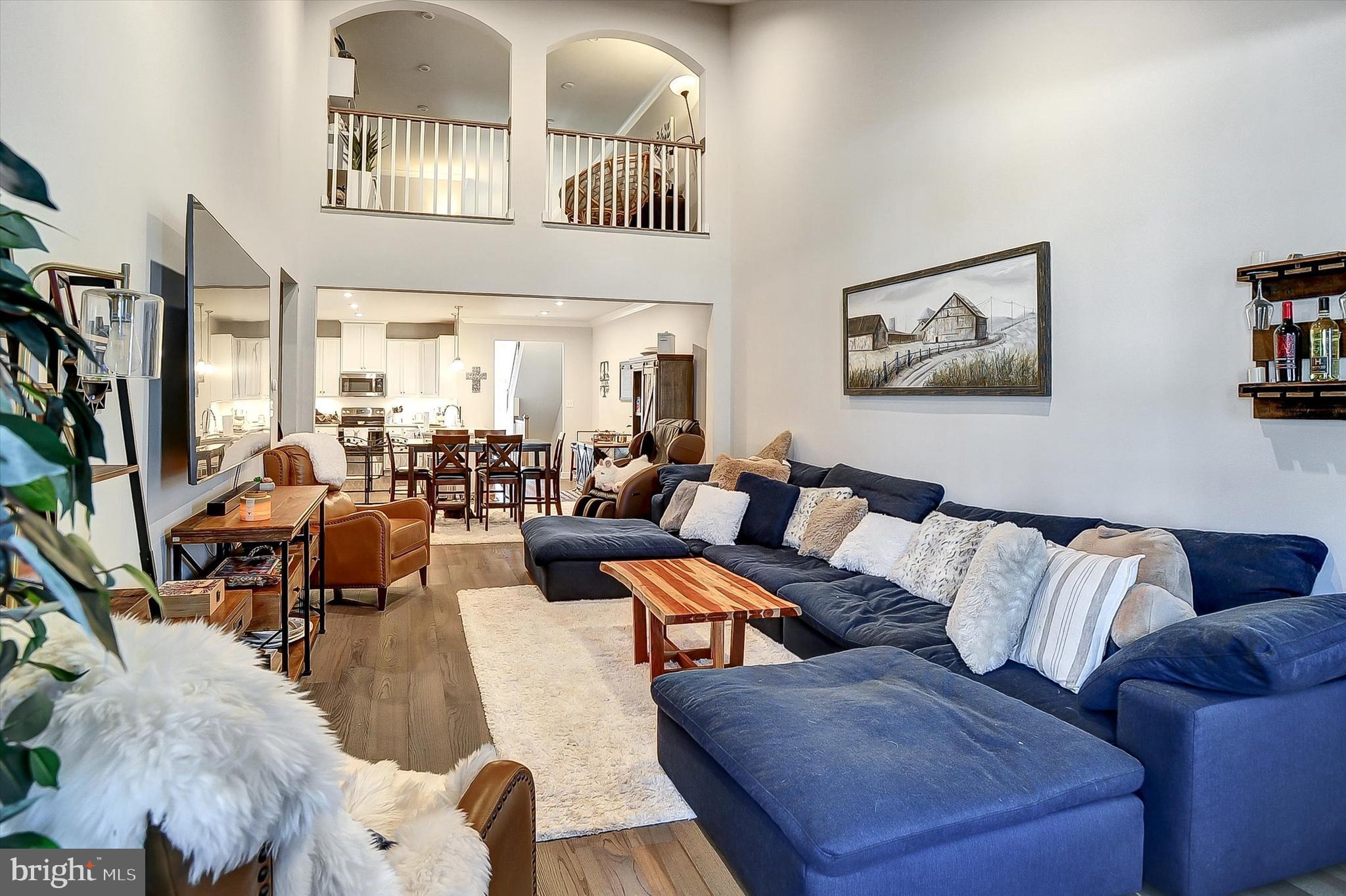 739 Cascade Way Kennett Square, PA 19348 - Photo 13 of 76 a living room with furniture wooden floor and a large window