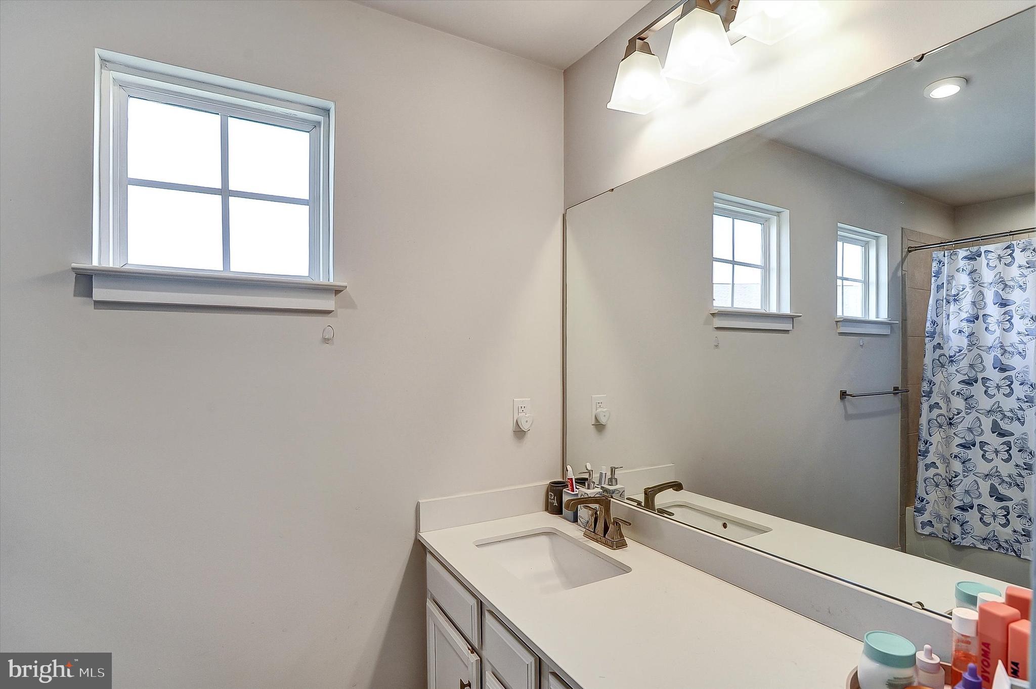 739 Cascade Way Kennett Square, PA 19348 - Photo 28 of 76 a bathroom with a sink a tub and a window