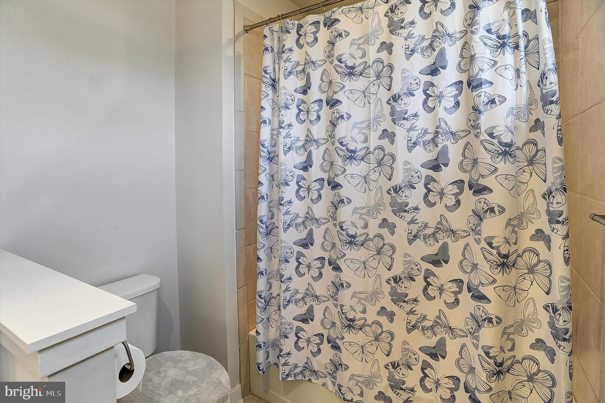 739 Cascade Way Kennett Square, PA 19348 - Photo 29 of 76 a bathroom with a toilet and a shower curtain