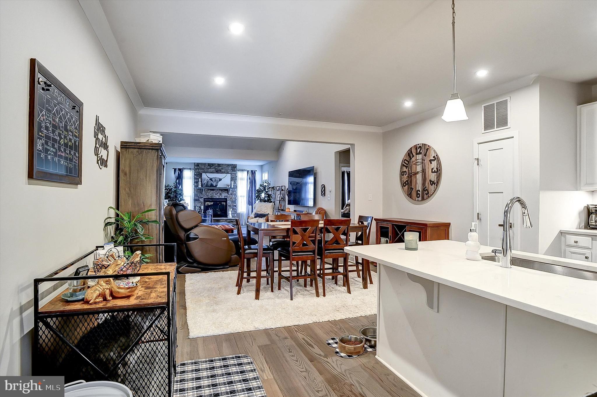 739 Cascade Way Kennett Square, PA 19348 - Photo 3 of 76 a view of a dining room and livingroom with furniture a rug a painting and a chandelier