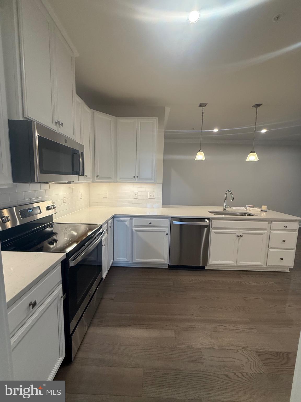 739 Cascade Way Kennett Square, PA 19348 - Photo 41 of 76 a kitchen with stainless steel appliances a stove sink and cabinets
