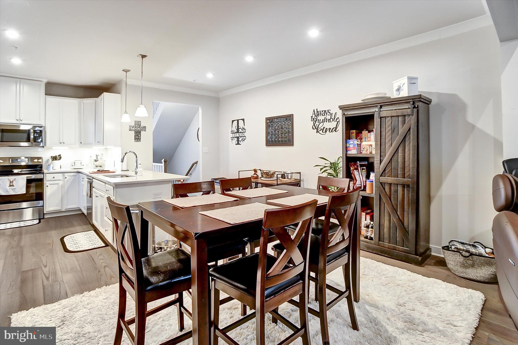 739 Cascade Way Kennett Square, PA 19348 - Photo 6 of 76 a kitchen with stainless steel appliances kitchen island granite countertop a dining table and chairs