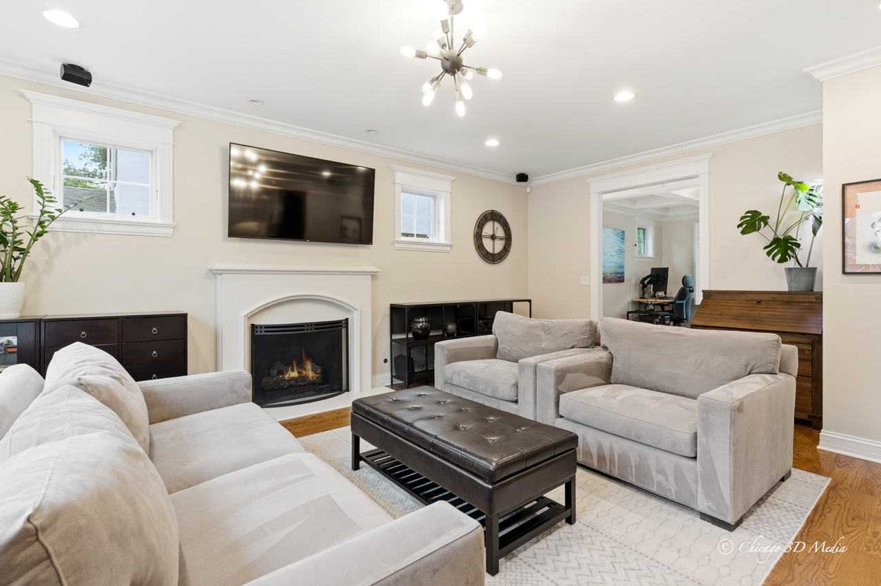 306 17th Street Wilmette, IL 60091 - Photo 8 of 48 a living room with furniture a fireplace and a flat screen tv